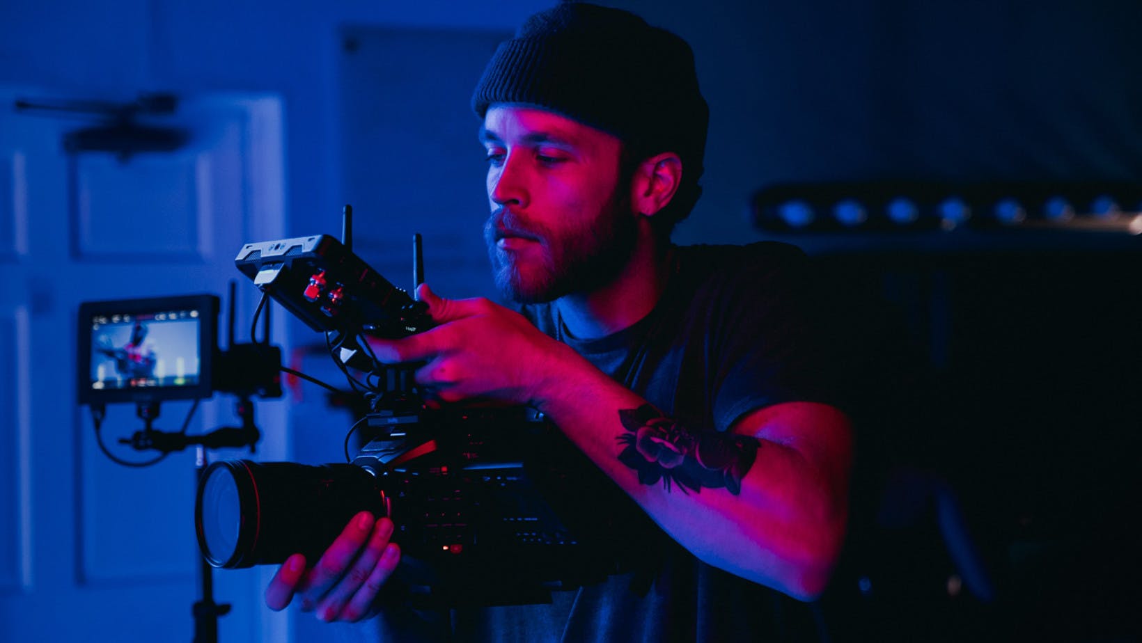 A bearded man with a video camera created a film. This represents a film degree that pays well.