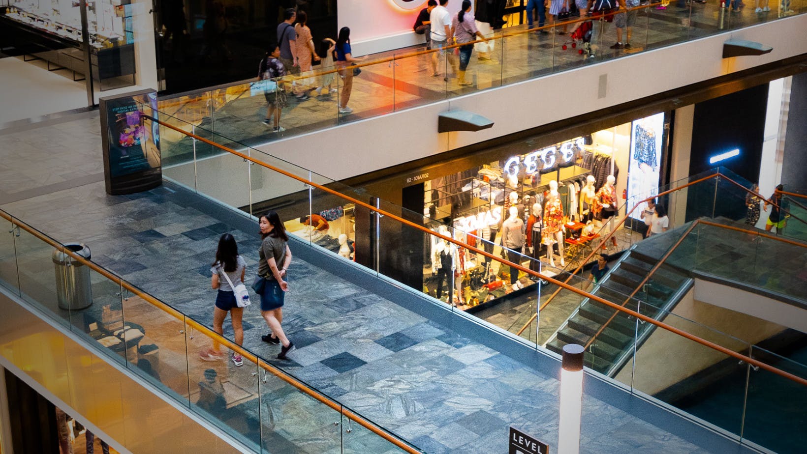 Shopping mall walkway view showing people walking
