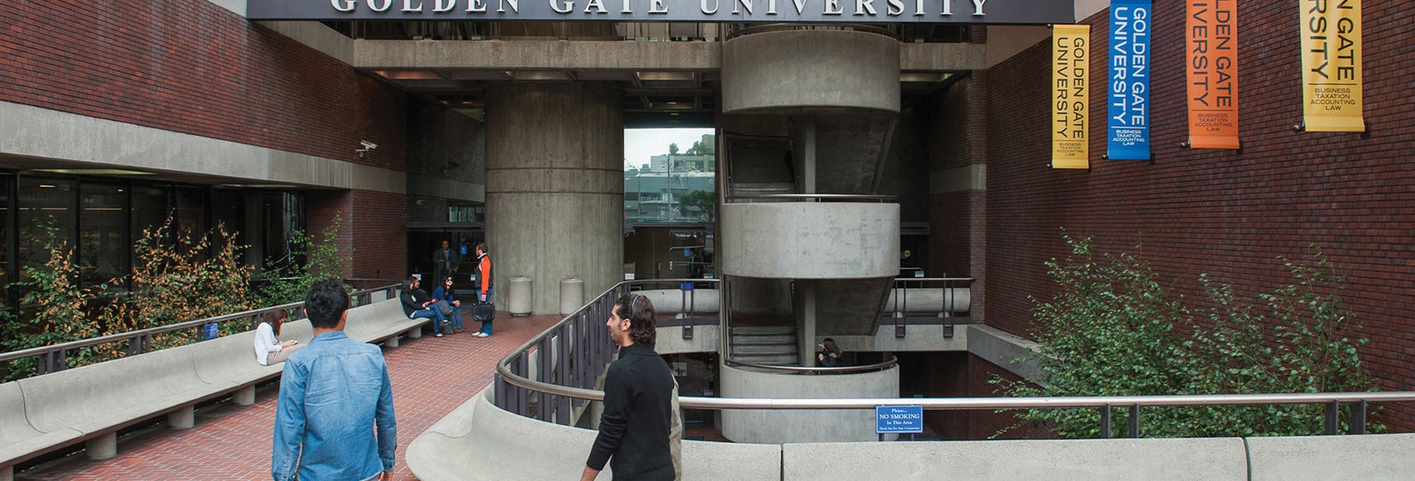 Outdoor view of Golden Gate University building with students walking