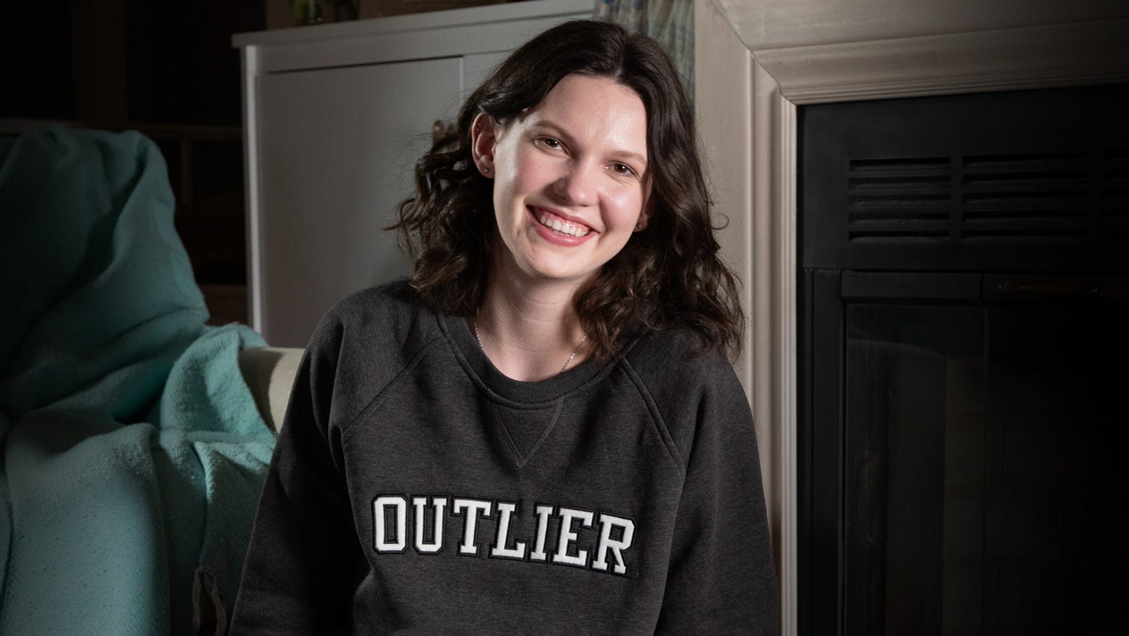 Female college student wearing and Outlier sweatshirt