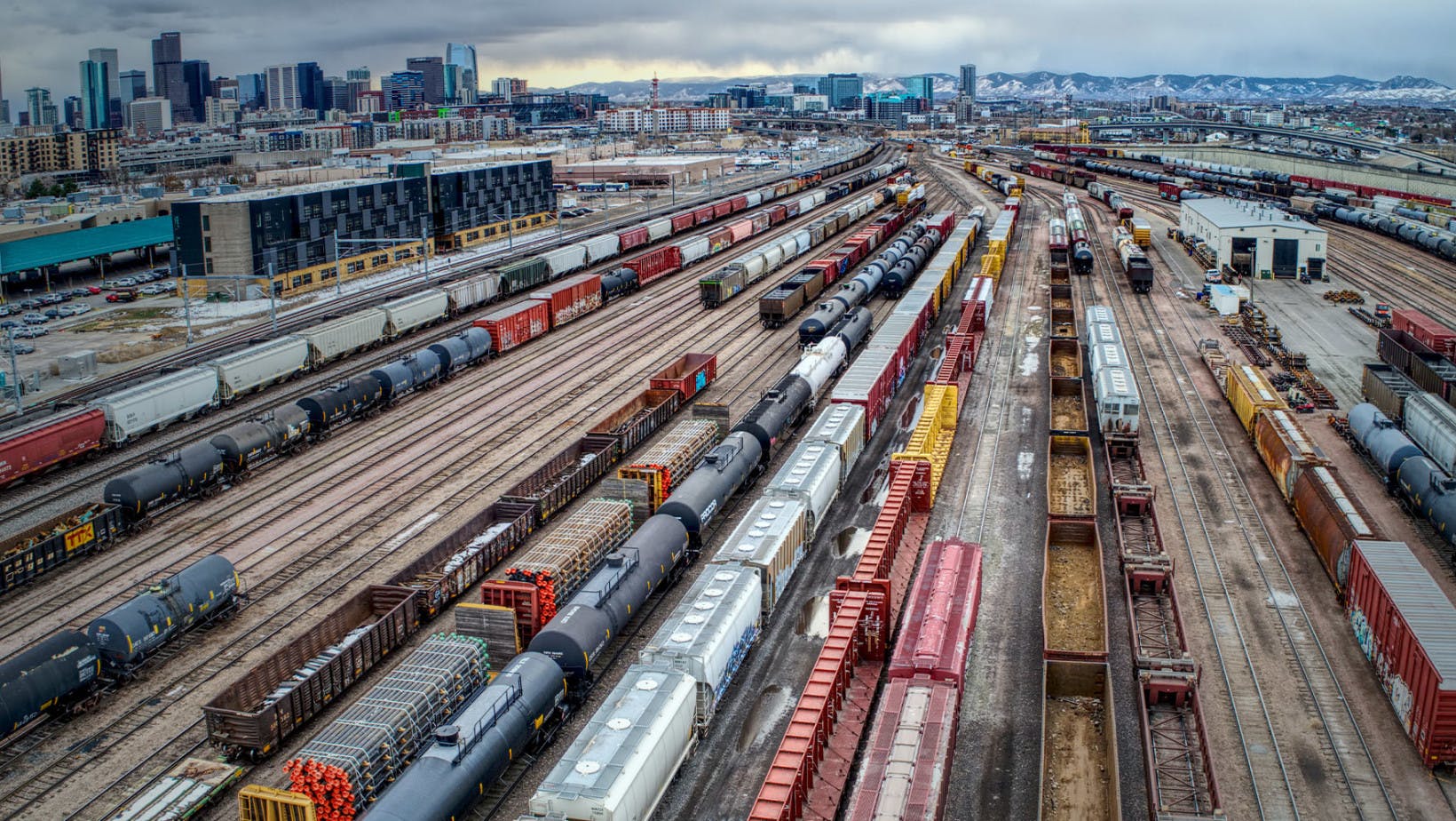 Multiple train tracks storing crates and containers of products and goods