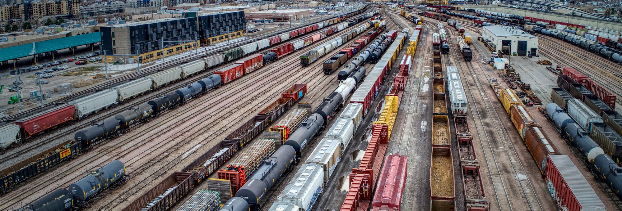 Multiple train tracks storing crates and containers of products and goods