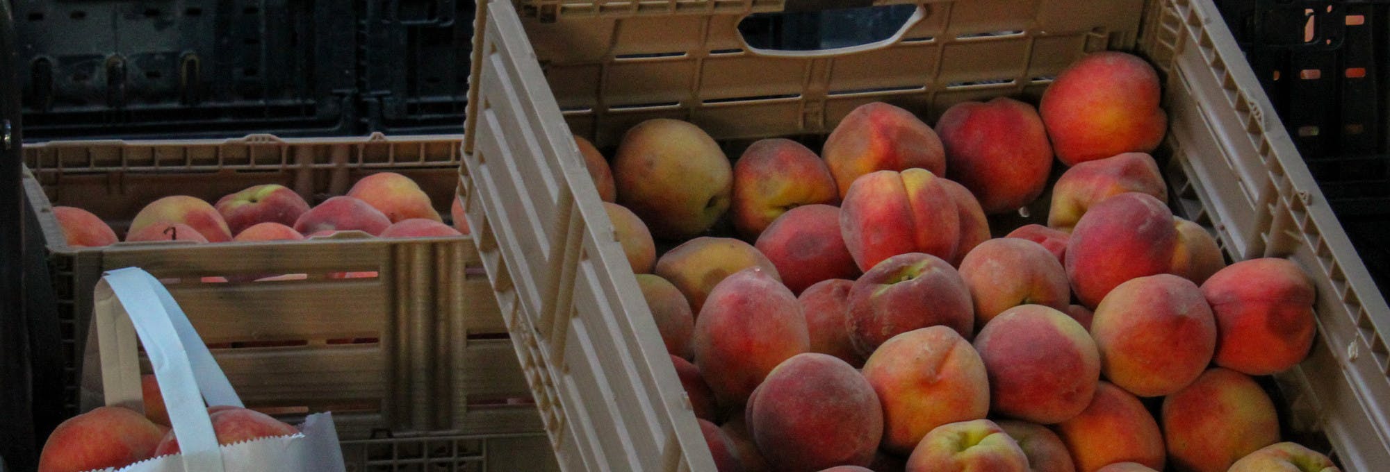basket of peaches for sale which represents total surplus